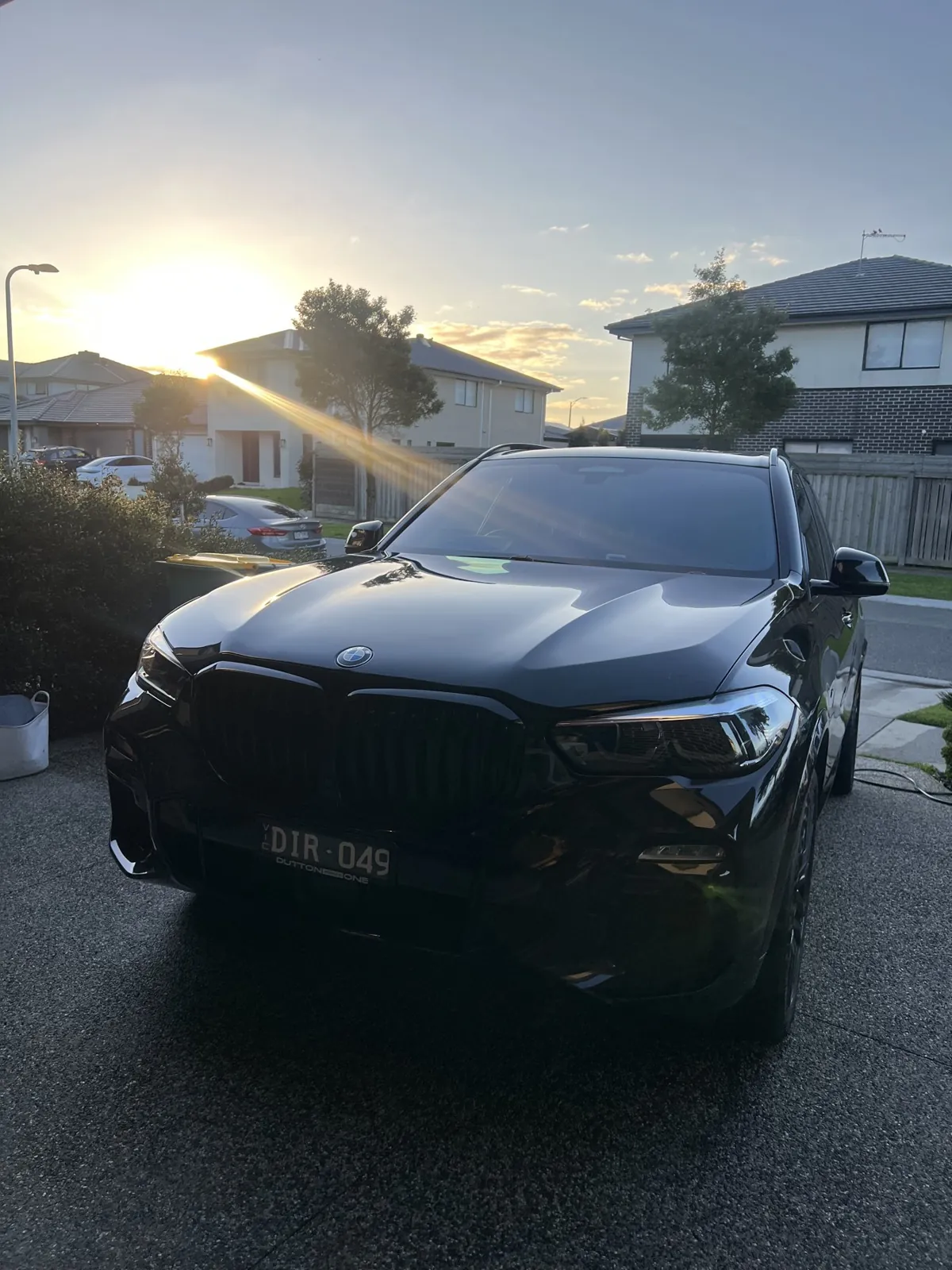 Black BMW SUV detailed at sunset on a Melbourne driveway