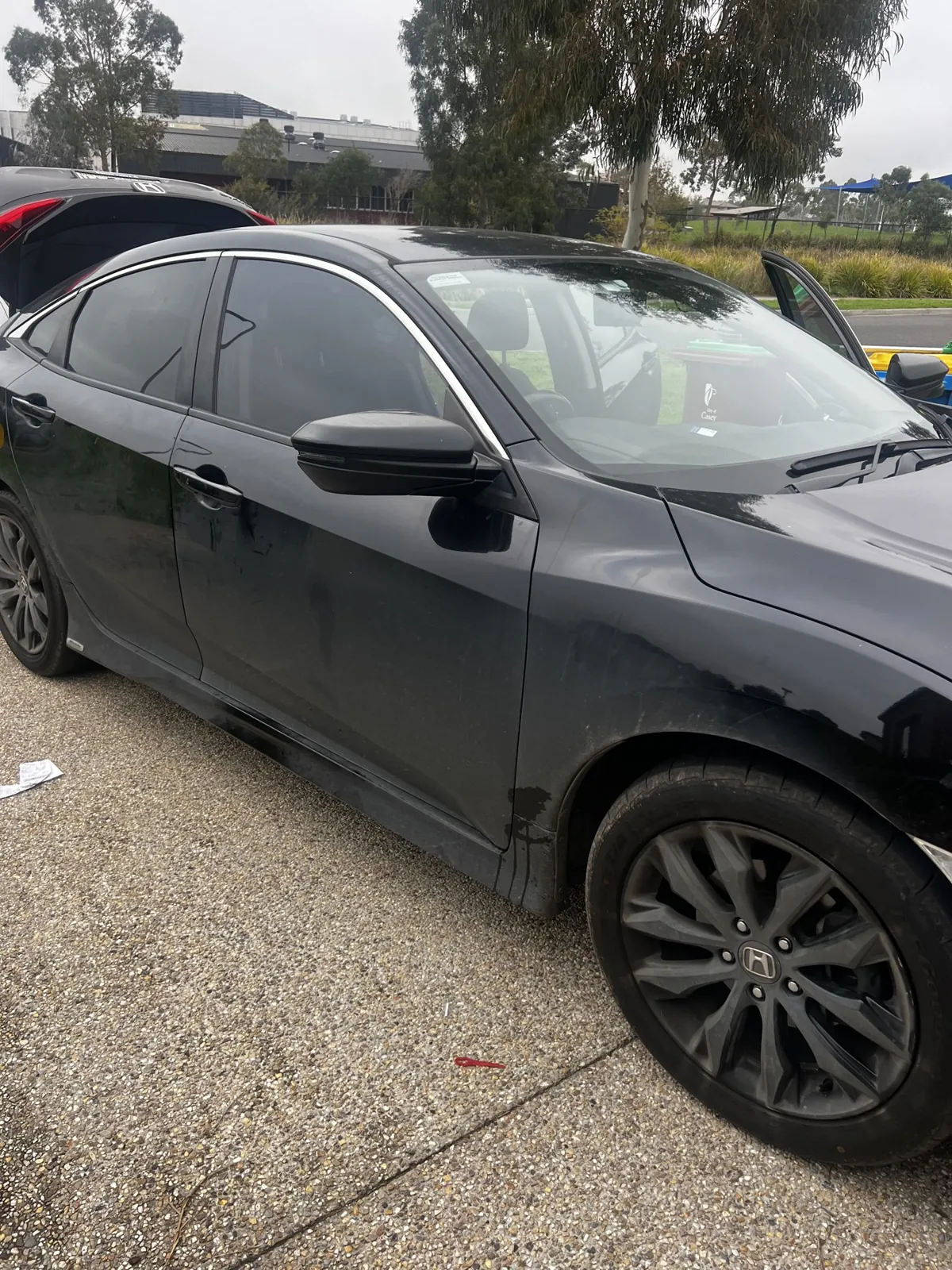Dark sedan paintwork before ceramic paint protection was applied