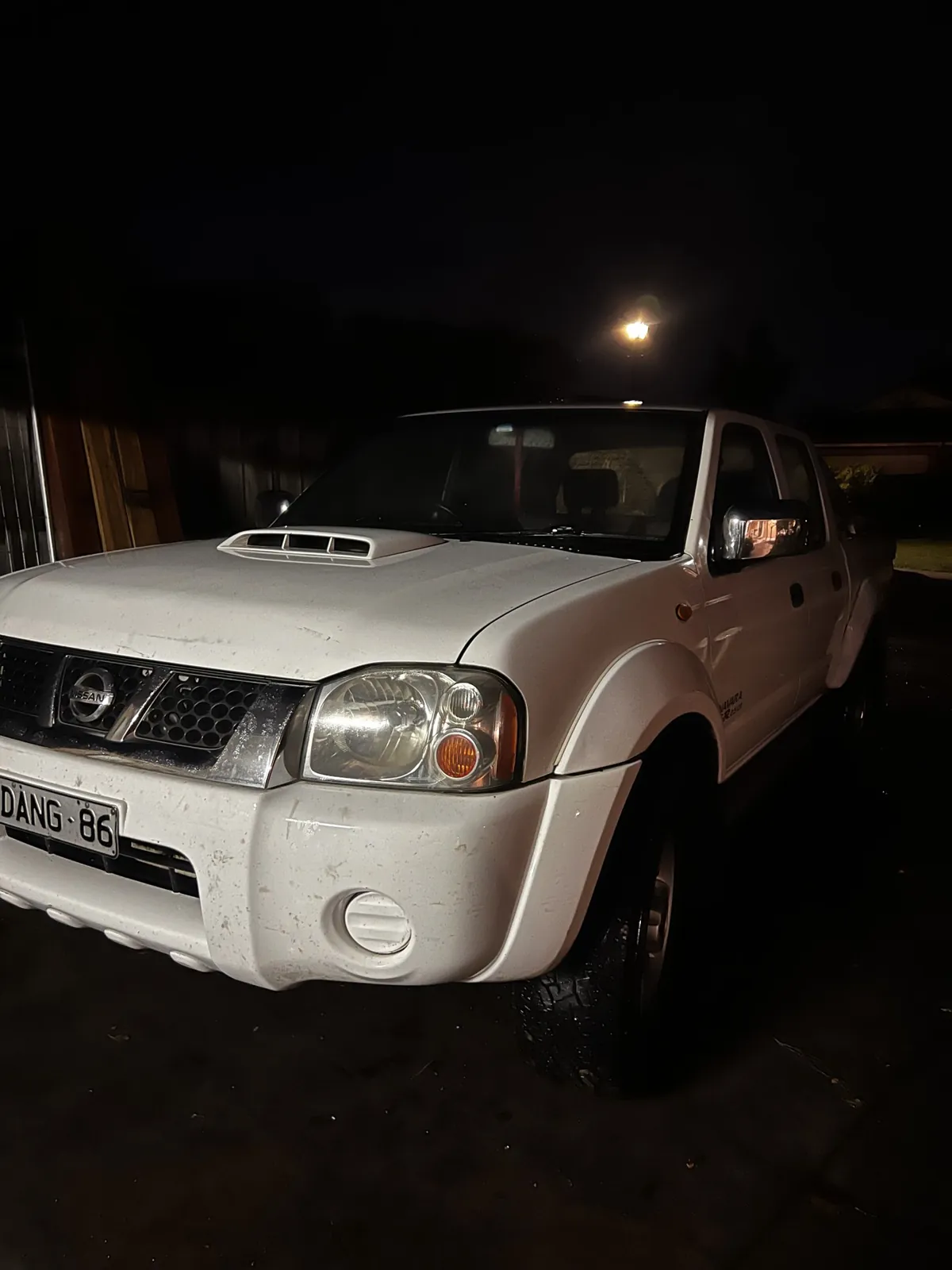 The same white Nissan ute cleaned and glossy after a tradie detail