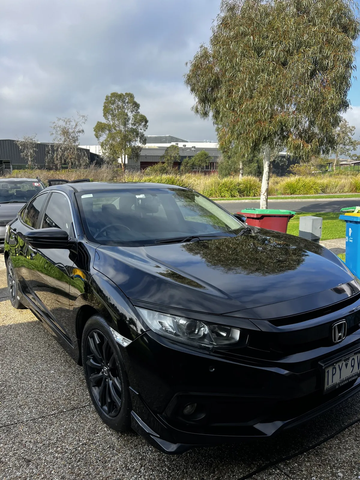Black Honda Civic with glossy paintwork after an exterior detail